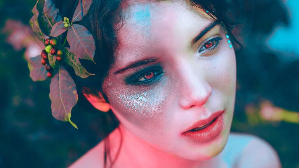 JLNICH blog beats article, Building Immersive High Fantasy Worlds: Tips and Tricks. Cover image, close up of woman's face with red eyes and scales