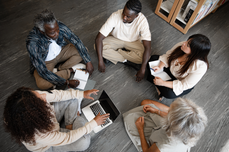 JLNICH blog beats article, Writing Beyond Limits: Fostering Inclusivity and Diversity during NaNoWriMo. Cover image, different people sitting and working together