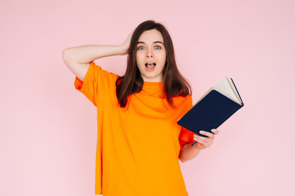 JLNICH blog beats article, Catch Readers by Surprise: The Unexpected Hook. woman holding book with surprised look on face.