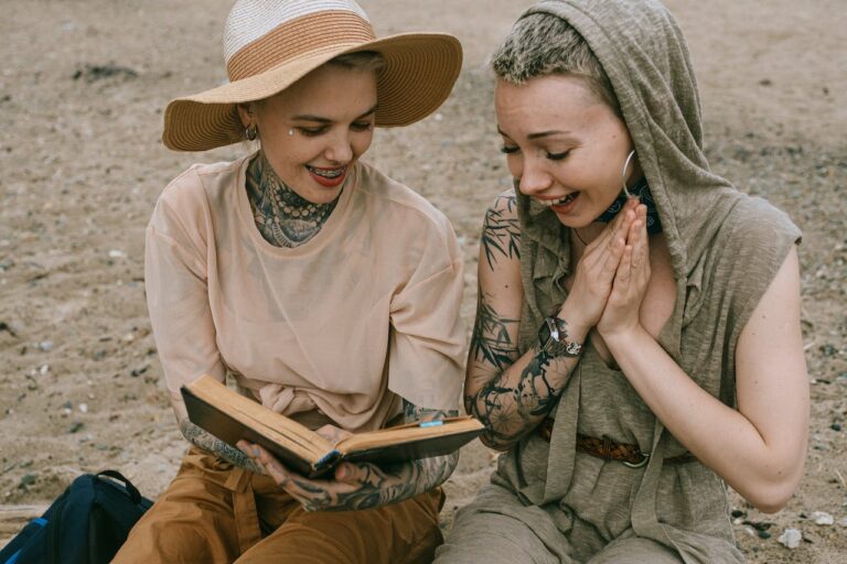 JLNICH blog beats article, Use the Power of Emotion: Persuasive Storytelling. Image of two women reading a book with a look of happyness