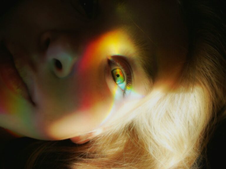 JL NICH blog beats article, Year-End Review of 2023. blog cover image, close up of woman's left eye with rainbow sun reflection